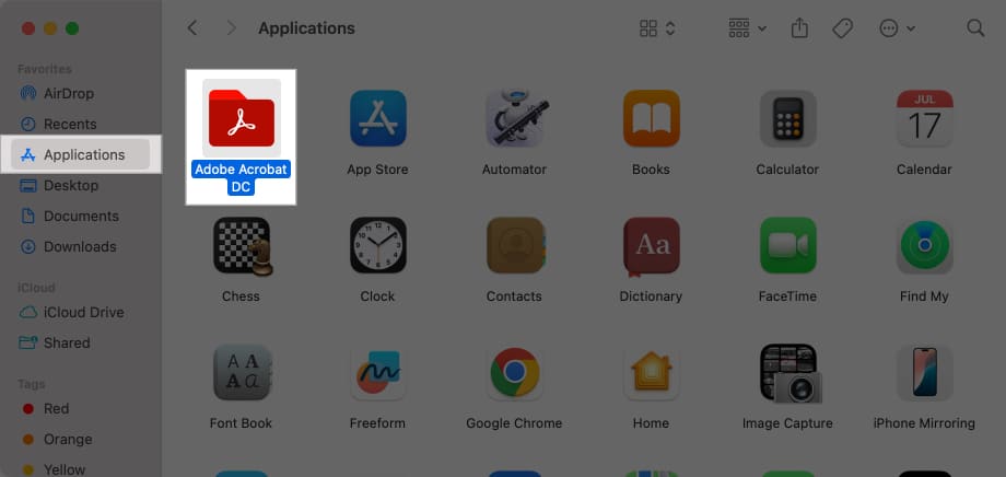 Dragging an app in Finder to Trash to delete it.