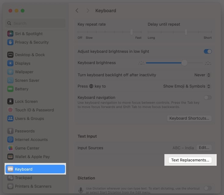 Accessing the Text Replacement option in macOS System Settings.