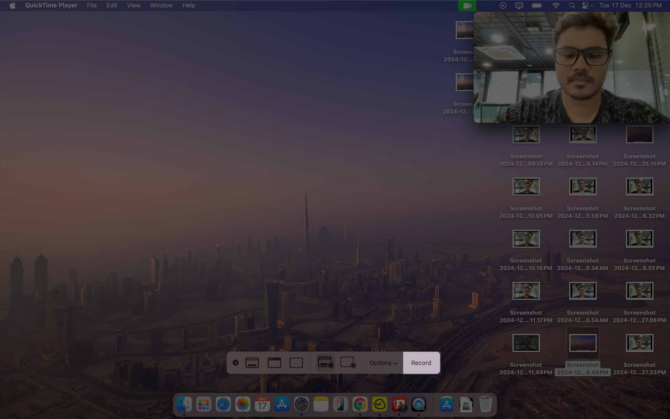 Clicking the record button to record the screen as well as the camera feed on a Mac.