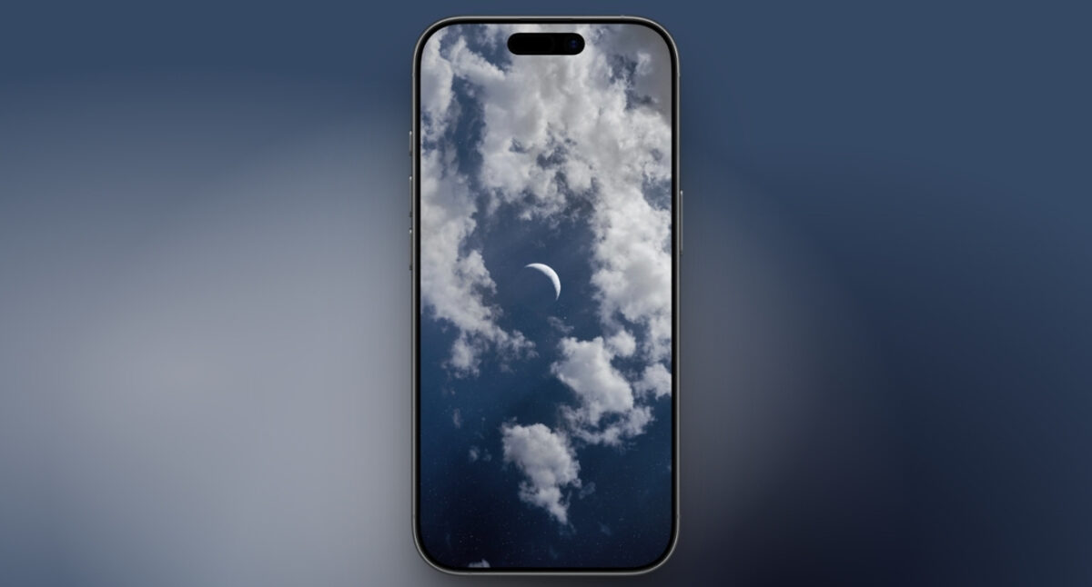 Moon crescent between clouds