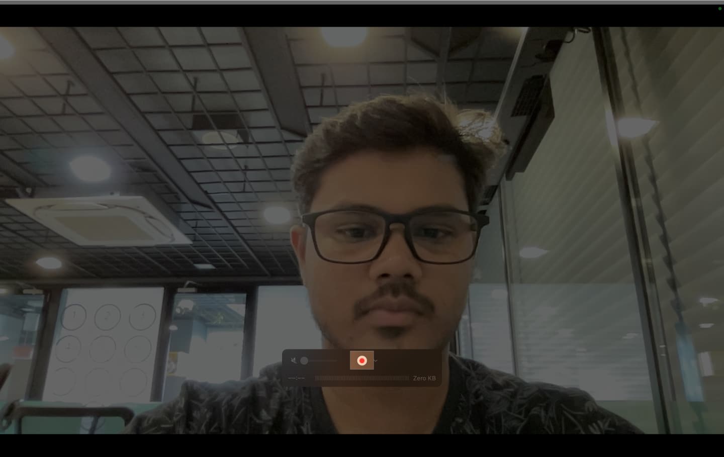 Clicking the record button in QuickTime Player to record a video.