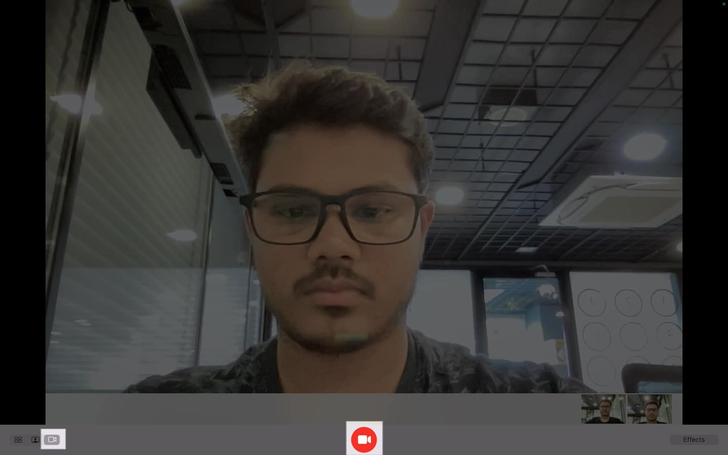 Clicking the camcorder button in Photo Booth to record a video on a Mac.