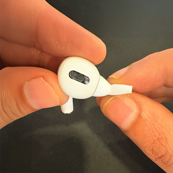 Gently pinch ear tip from bottom without using nails