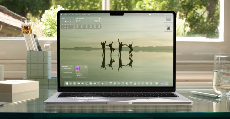 MacBook Air displaying macOS Tahoe 26 on a desk