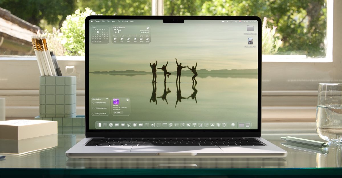 MacBook Air displaying macOS Tahoe 26 on a desk
