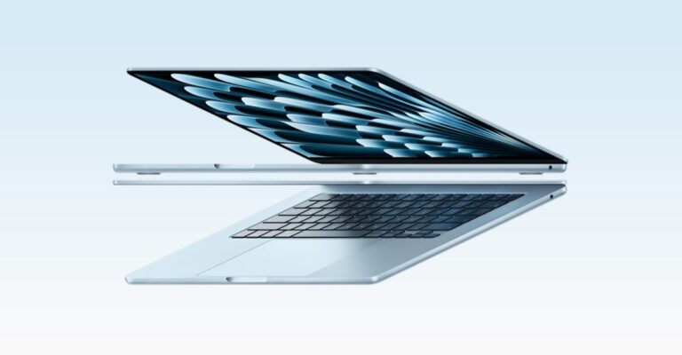 Slim silver laptop opened at an angle, floating mid-air against a pale blue gradient background.