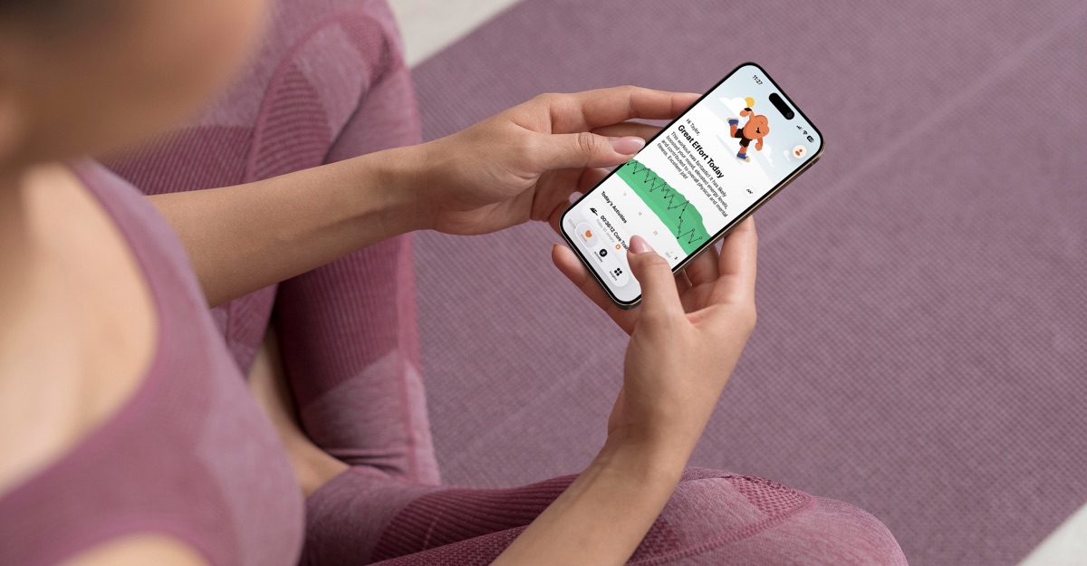 A person holds an iPhone showing the Gentler Streak activity path.