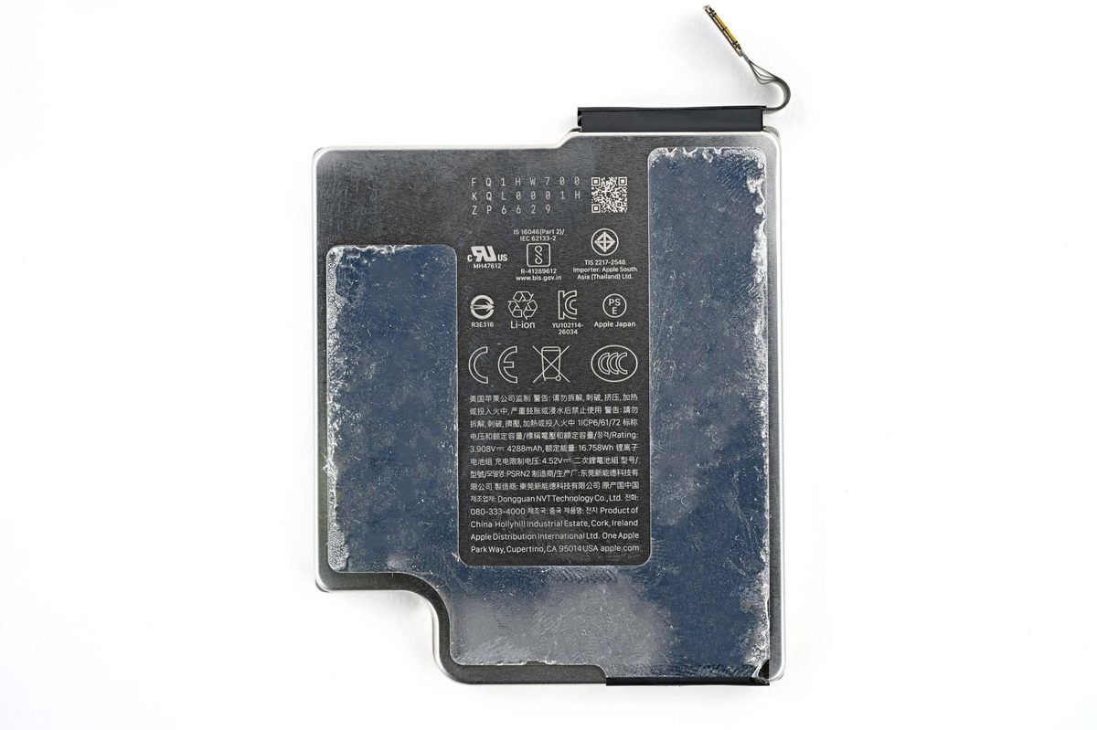 iFixit teardown view of iPhone 18 Pro battery tray removed showing 4,288 mAh cell and screwed-in metal tray