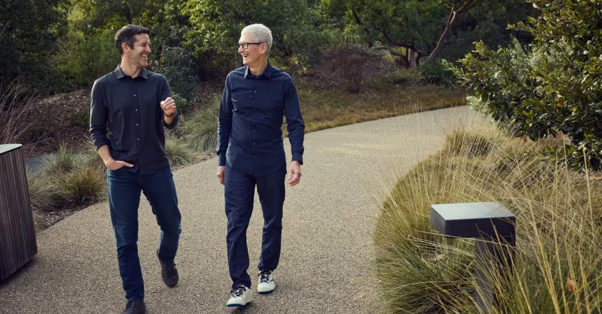 Apple CEO John Ternus and former CEO Tim Cook walking at Apple Park.